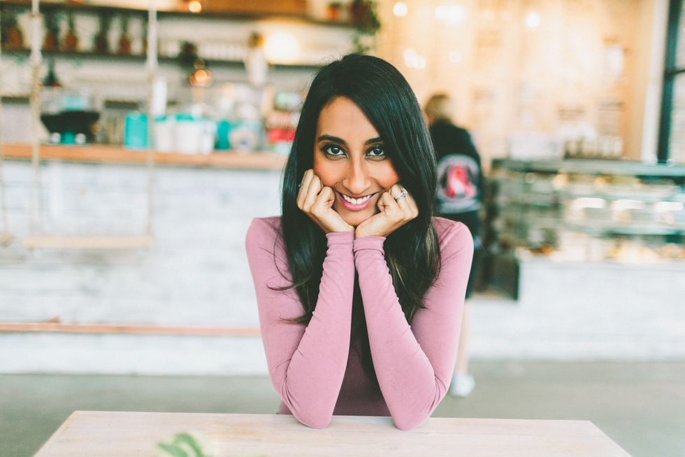 woman sitting at table with long black hair